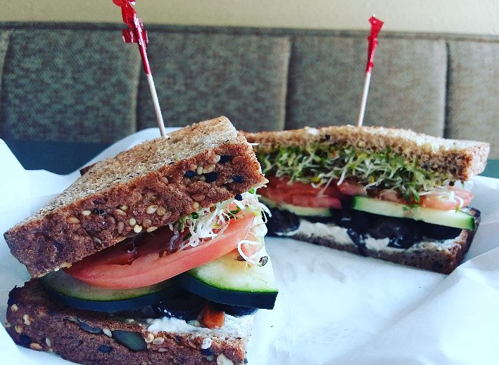 Vegetarian sandwich on rye with cucumber, tomato, sprouts and avocado